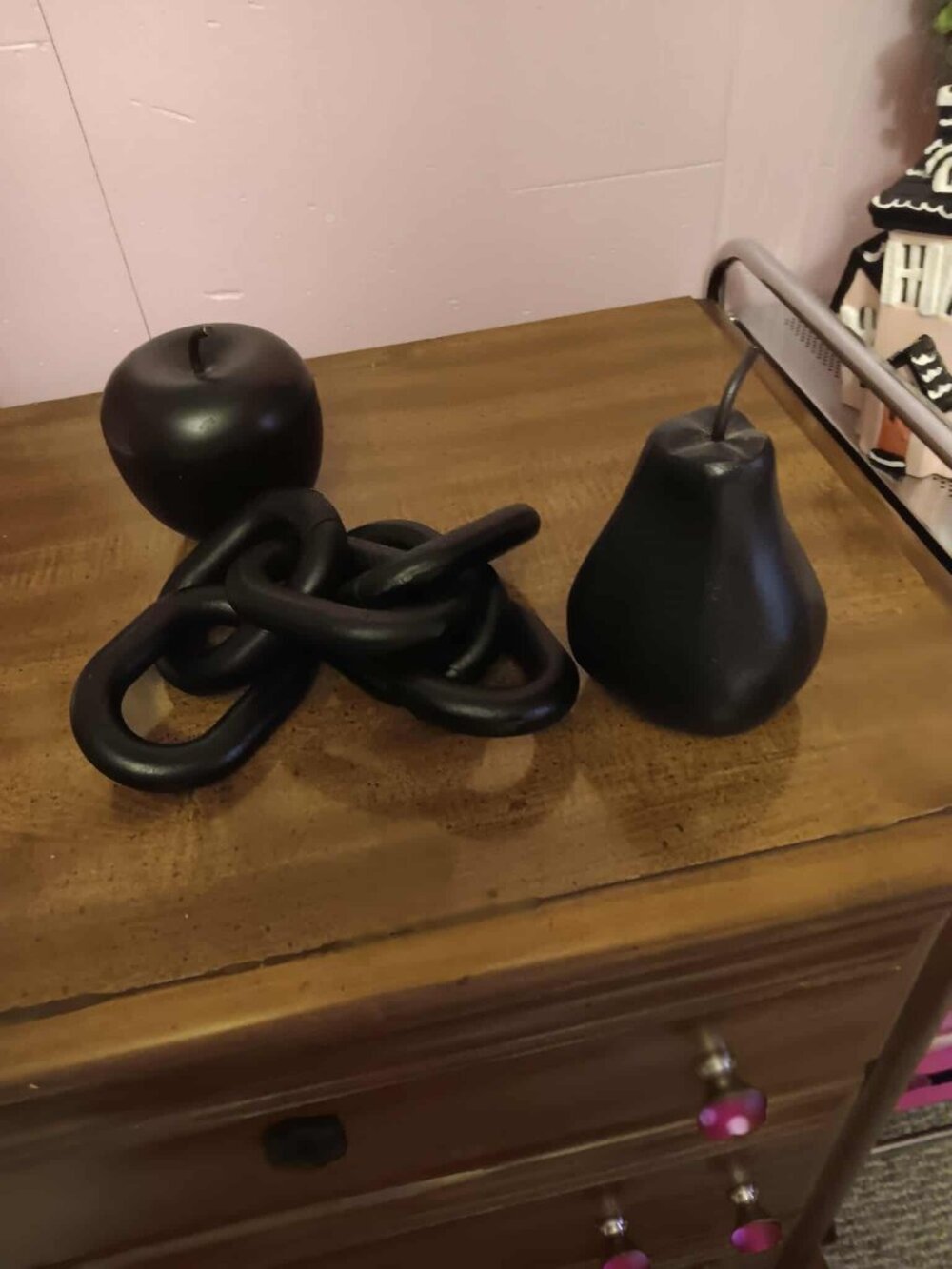 Three black wood Halloween items, pear, apple and chain